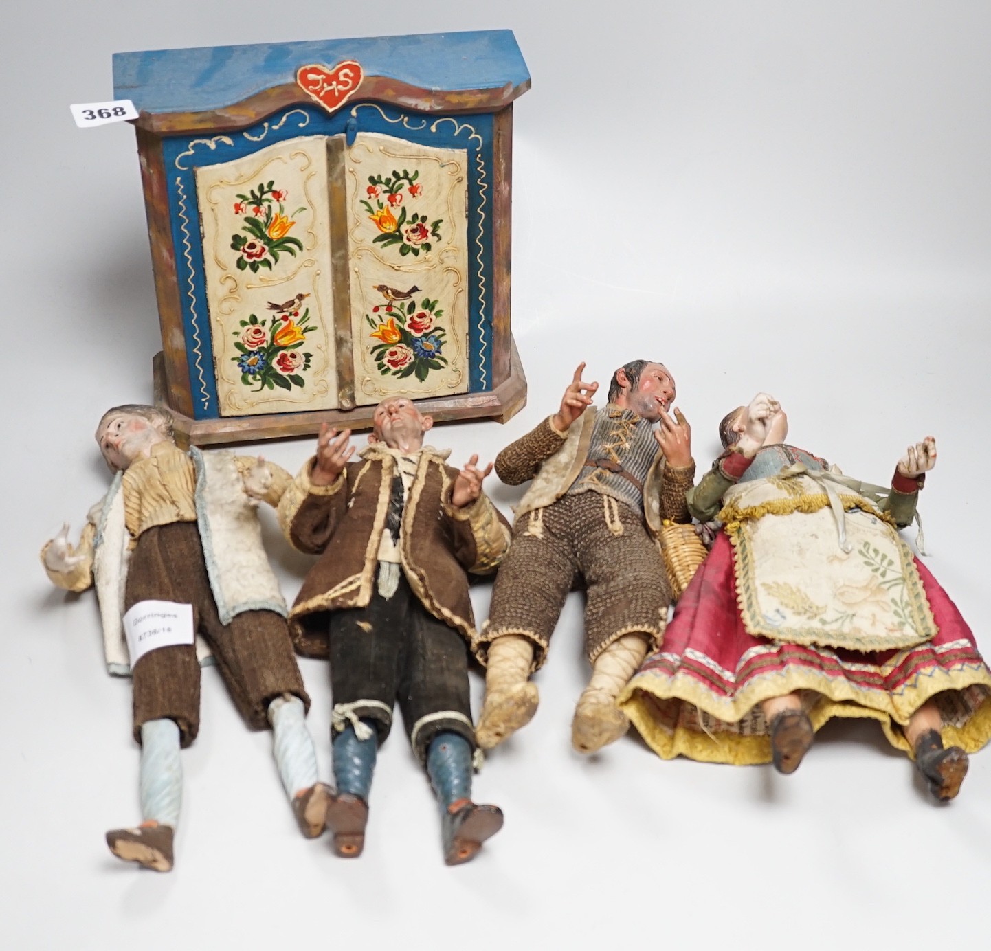 Four 18th/19th century Neapolitan painted wood or terracotta crèche figures, tallest 31.5cm and a 20th century miniature Bauernschrank